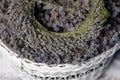 A wreath of lavender flowers in a white basket with selective focus on a blurred background. Copy space Royalty Free Stock Photo