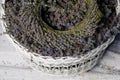 A wreath of lavender flowers in a white basket with selective focus on a blurred background. Copy space Royalty Free Stock Photo