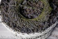 A wreath of lavender flowers in a white basket with selective focus on a blurred background. Copy space Royalty Free Stock Photo