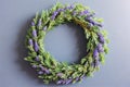 A wreath of lavender sprigs on a blue background, AI generated. Royalty Free Stock Photo