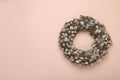 Wreath made of beautiful willow flowers on beige background, top view. Space for text Royalty Free Stock Photo