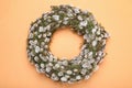 Wreath made of beautiful willow flowers on orange background, top view Royalty Free Stock Photo