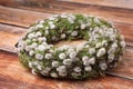 Wreath made of beautiful willow flowers on wooden table, closeup Royalty Free Stock Photo