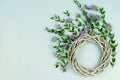 Wreath made of wicker circle, the branches of eucalyptus and purple flowers