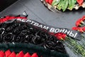 A wreath with a mourning ribbon to the victims of the war is laid on the monument Royalty Free Stock Photo