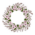 A wreath of pink cherry blossoms and bright green leaves along with young willow branches on a white background. Natural round fra