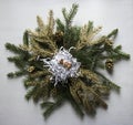 On a wreath of spruce branches and golden twigs and cones lies t Royalty Free Stock Photo