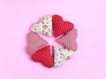 Wreath of textile soft hearts on a pink background. Valentine`s day hearts made of cotton fabric are made with your own hands Royalty Free Stock Photo