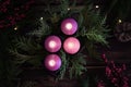 Wreath with three purple and one pink advent candles Royalty Free Stock Photo