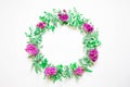 A wreath of violets on a white background. Round frame of purple flowers and fresh grass. Summer flowers. Flat lay, top view.