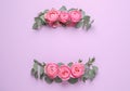 Wreathes made of beautiful flowers and green leaves on violet background, flat lay. Space for text