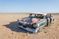 Wreck of classic saloon car abandoned deep in the Namib Desert of Angola Royalty Free Stock Photo