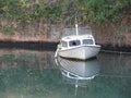 The wreck of a partially submerged boat in the harbor