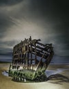 Wreck of the Peter Iredale reflected in a water surface under the breathtaking clouds Royalty Free Stock Photo