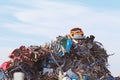 The wreck of a retro car Fiat 126p Polish production on top of a mountain of metal scrap. Disposal of old and broken cars. Landfil