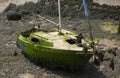Wreck of a small yacht on river mud