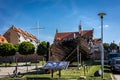 Wreck of a wooden ship and historical townhall building in Kamien Pomorski, Poland.