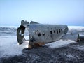 The wreckage of an abandoned DC 3 plane on a black ocean beach in Iceland. Popular attractions in Iceland Royalty Free Stock Photo