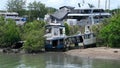 The wreckage of a fishing boat, a wreck, is abandoned and rotting near the coast in the port of Phuket, Thailand