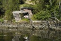 Wrecked boat in a derelict boat house refelection river Royalty Free Stock Photo