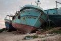 wrecked boats ships shipwreck on shore leaning against one another, close up 135 ph