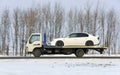 wrecker carries the car of white color