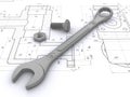 Wrench, bolt and nut against engineering drawings Royalty Free Stock Photo