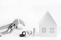 Wrench bolt and nuts. Miniature paper house. Building renovation and maintenance concept. On a white background