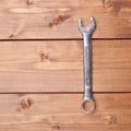 Wrench chrome metal spanner instrument on wooden surface