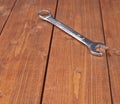 Wrench chrome metal spanner instrument on wooden surface
