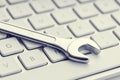 Wrench on computer keyboard Royalty Free Stock Photo