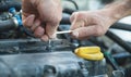 Wrench in hand. Man working in repair service and fixing car engine