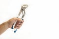 Wrench in hand. On a white background. Isolated. Repair services. Plumbing