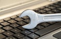 Wrench lying on keyboard symbolizing computer maintenance