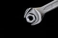 Wrench and metal nut isolated on black background Royalty Free Stock Photo