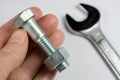 Wrench, Nut and Bolt in Hand