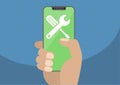 Wrench and screwdriver icon on modern bezel-free / frameless smartphone touchscreen.Hand holding smartphone