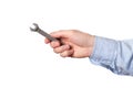 Wrench, spanner. Hand holding a metal wrench on white background