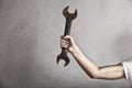 Wrench spanner tool in hand of female worker Royalty Free Stock Photo