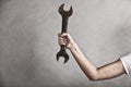 Wrench spanner tool in hand of female worker Royalty Free Stock Photo