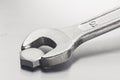 Wrench tightens  bolt in steel billet. Spanner, bolt, screw and nuts Royalty Free Stock Photo