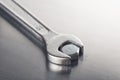 Wrench tightens  bolt in steel billet. Spanner, bolt, screw and nuts Royalty Free Stock Photo