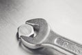 Wrench tightens  bolt in steel billet. Spanner, bolt, screw and nuts Royalty Free Stock Photo