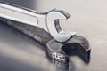 Wrench tightens  bolt in steel billet. Spanner, bolt, screw and nuts Royalty Free Stock Photo