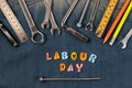 Wrench tools on a denim workers with space for text. Happy Labour Day. Royalty Free Stock Photo