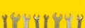 Wrench tools wide web banner, repair tool and contruction equipment concept background, yellow office table top view and