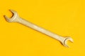 Wrench on yellow background with copy space. working tool