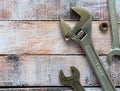 Wrenches on a background of colored wooden surface. Space for text. Background for business, industry