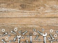 Wrenches, bolts, nuts and washers on wooden background. Royalty Free Stock Photo