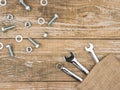 Wrenches, bolts and nuts on wooden background.